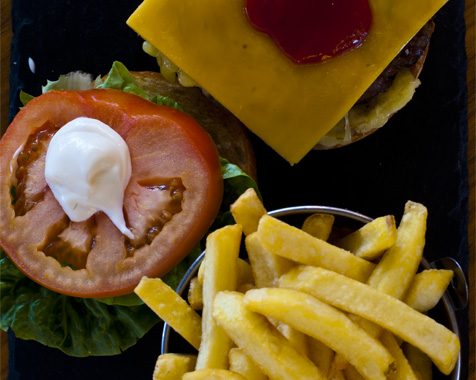 Open beef burger with cheese and fries