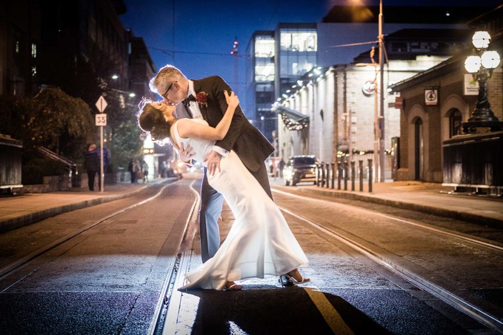 Wedding couple kissing on the Luas rails