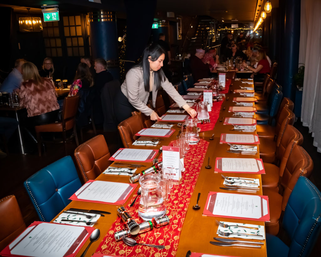 Elizabeth setting Christmas table at Harbourmaster